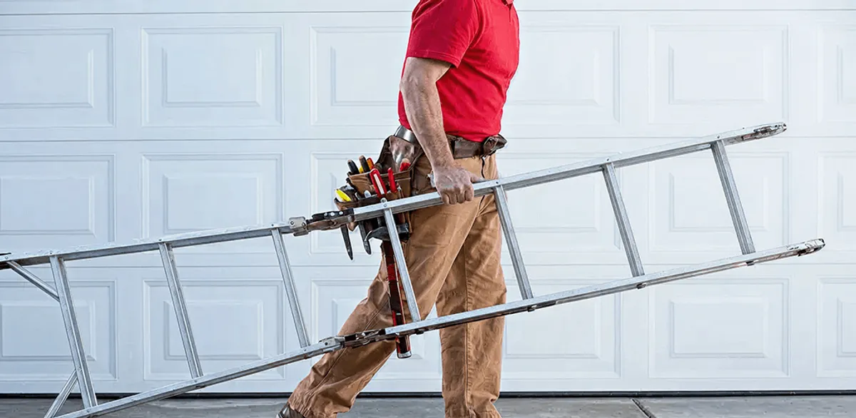 Garage door repair technician arriving with tools and ladder in Evansville, IN