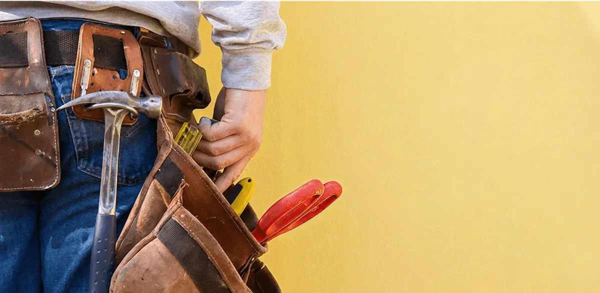 Handyman with tool belt ready for home repairs and maintenance in Evansville, IN